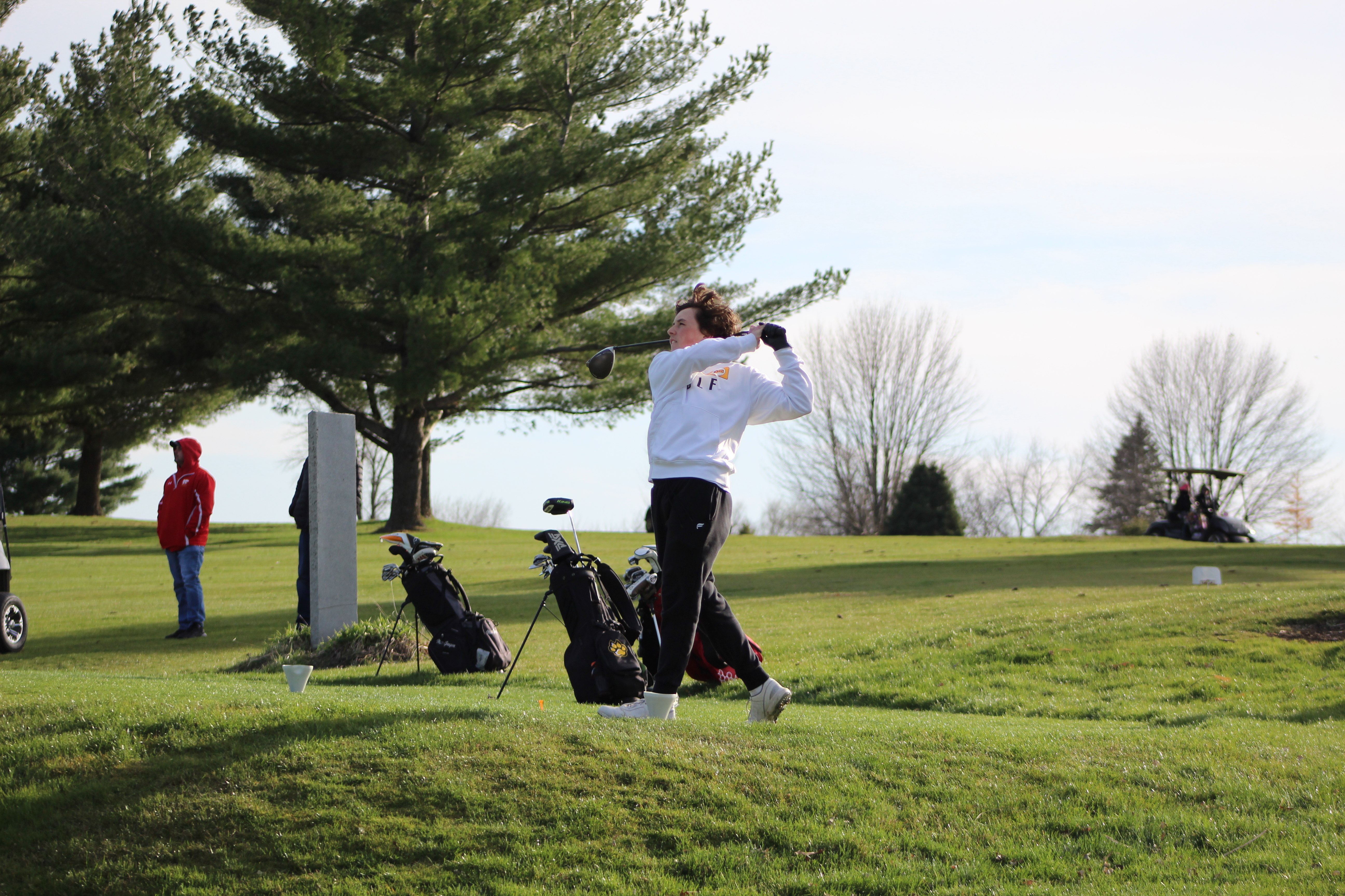 student playing golf