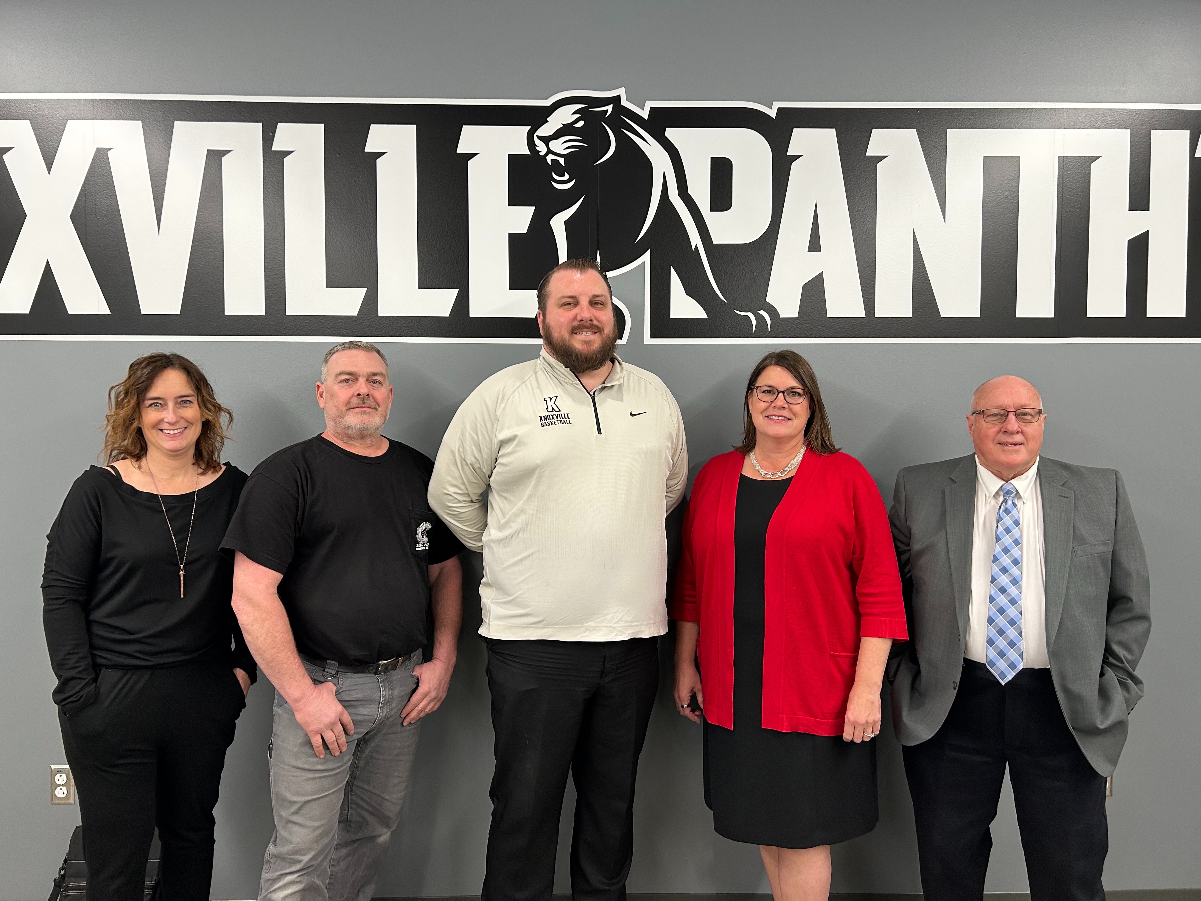 5 Knoxville school board members posing at a computer desk