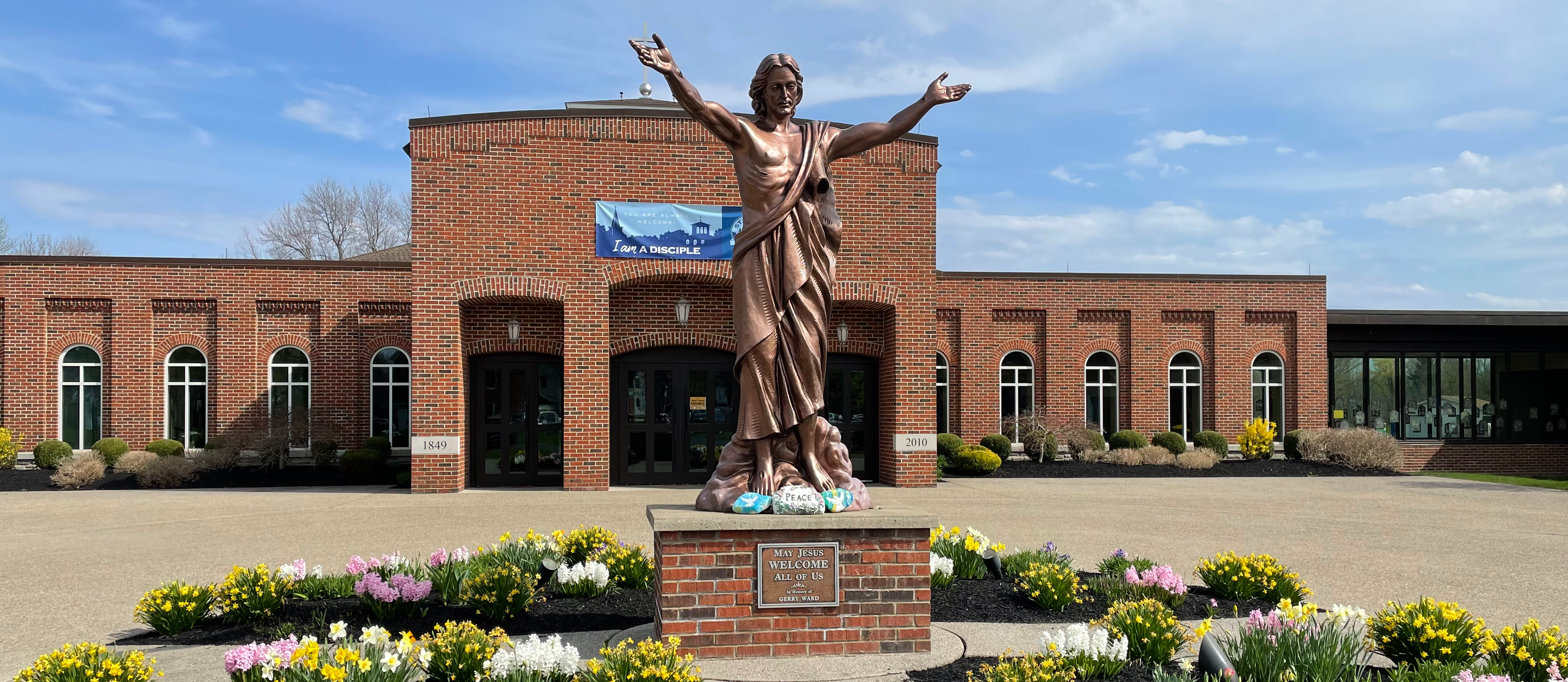 Statue of Jesus in front of a church