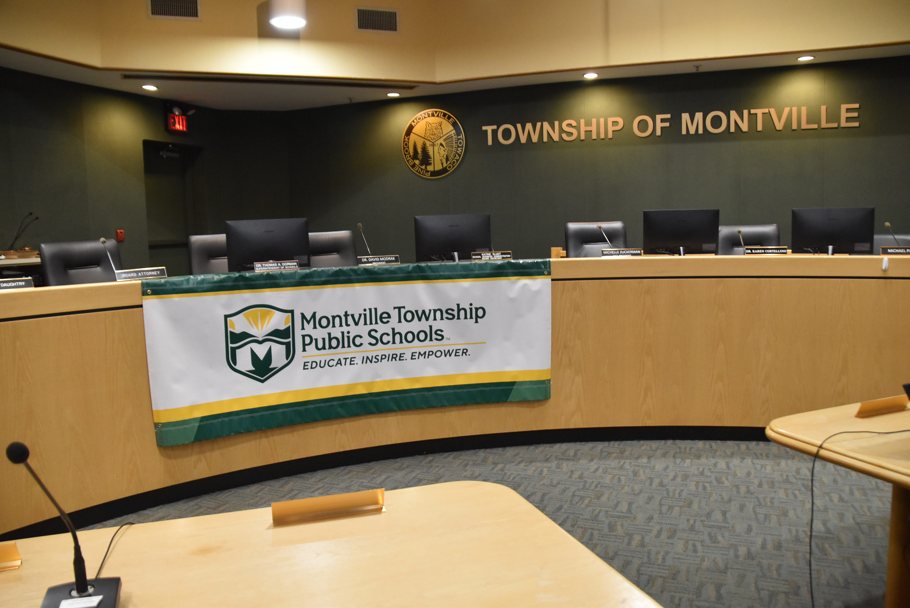 Montville Township Public Schools banner with logo and motto: Educate. Inspire. Empower. On the dais at Montville Township Municipal Building.