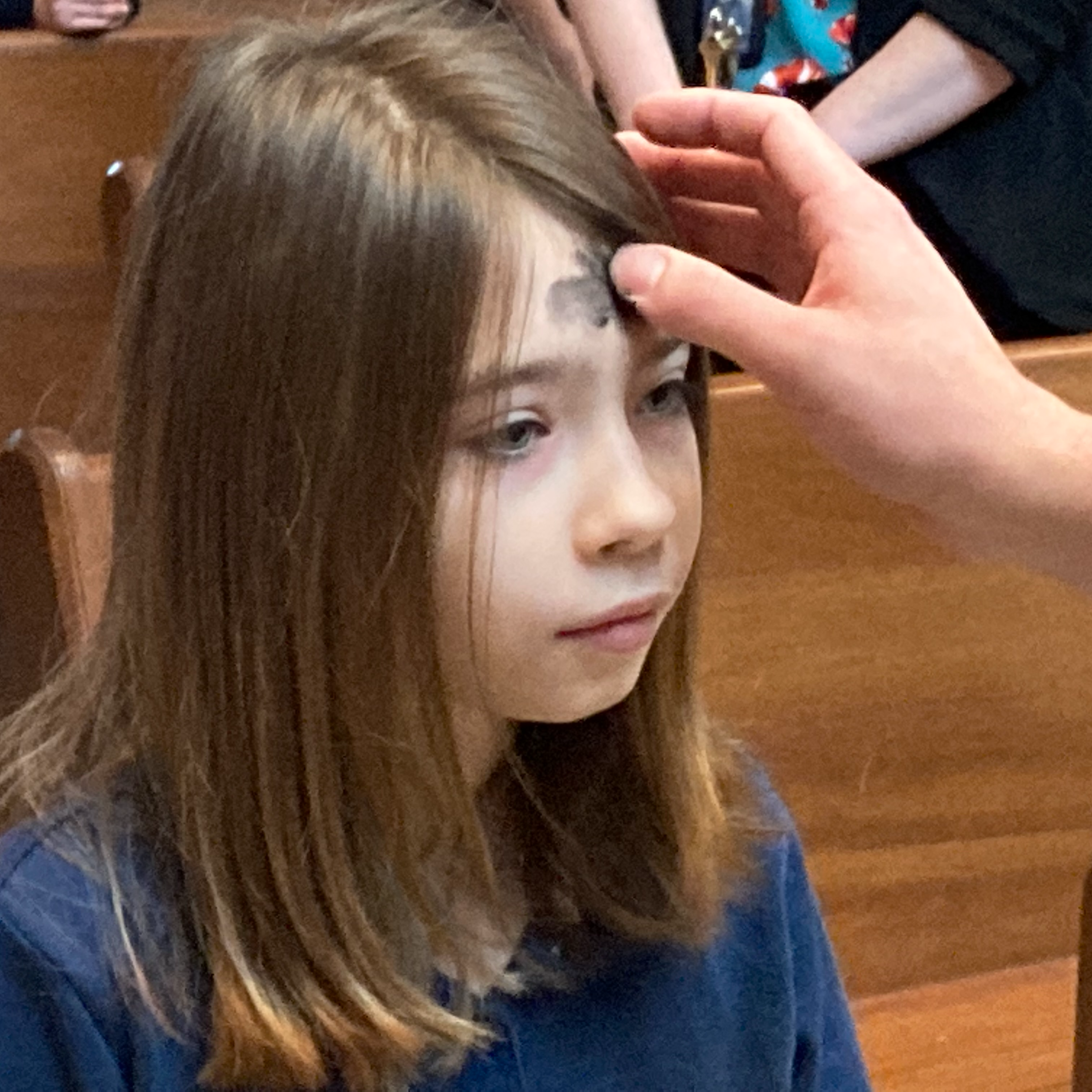 Child receiving ashes on forehead