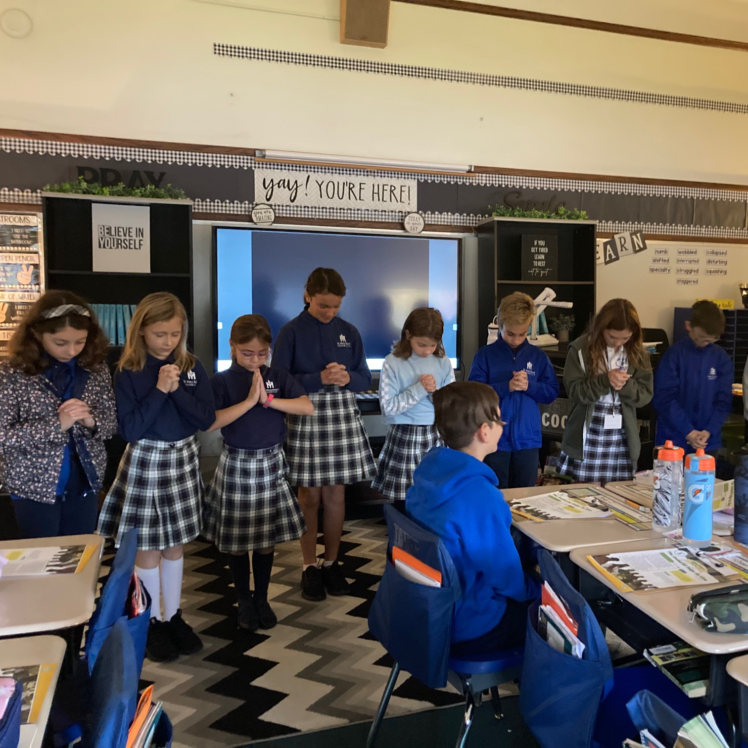 Cjildren praying in a classroom