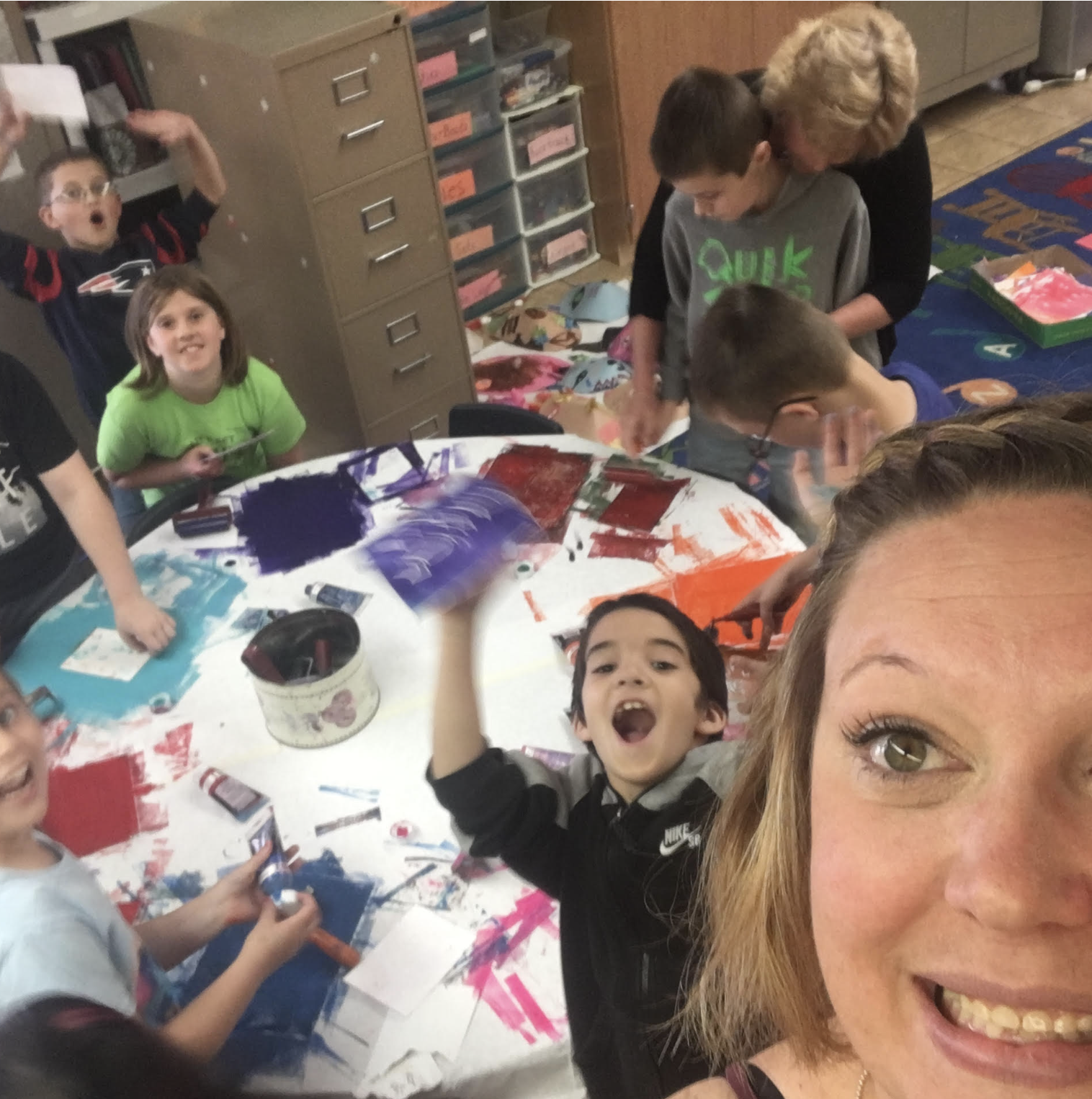 Mrs. Hazelton with the kids painting