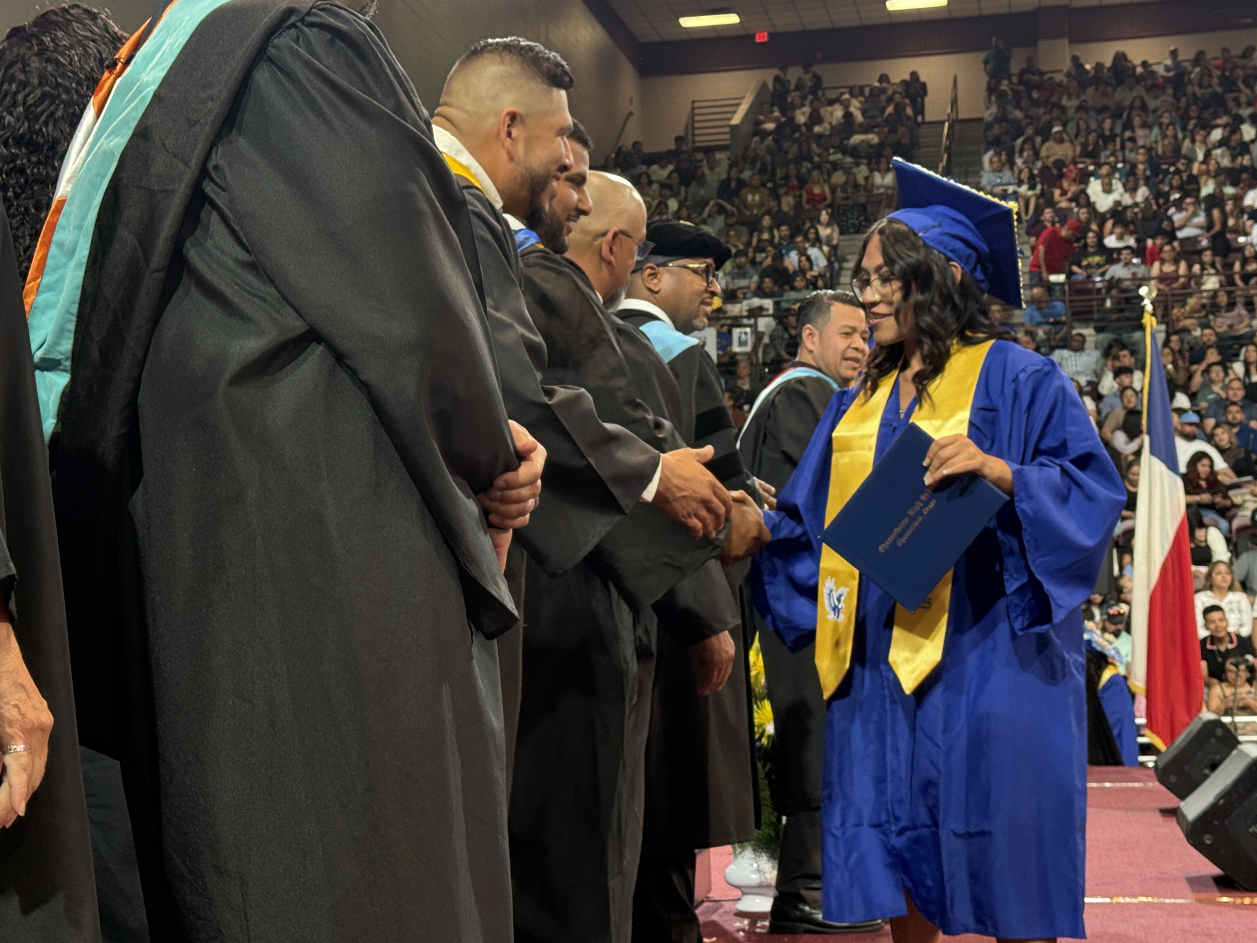 Student graduation. Board of trustees shaking hands.