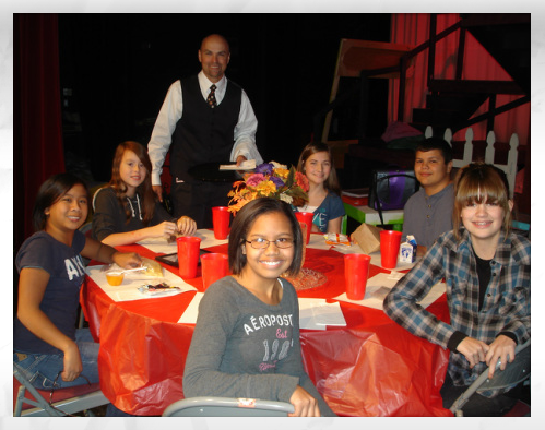 students around a table smiling 