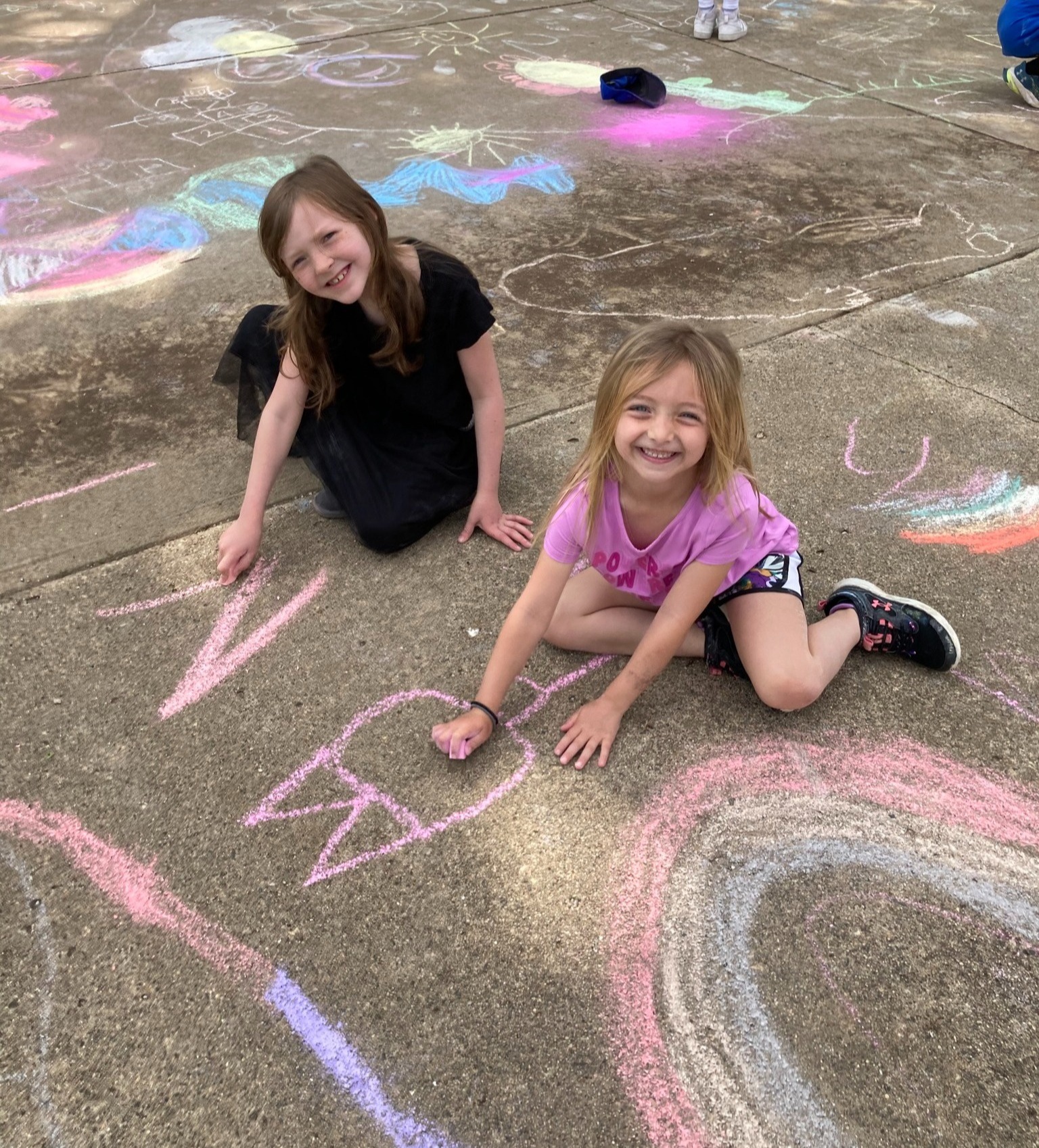 Students drawing with sidewalk chalk