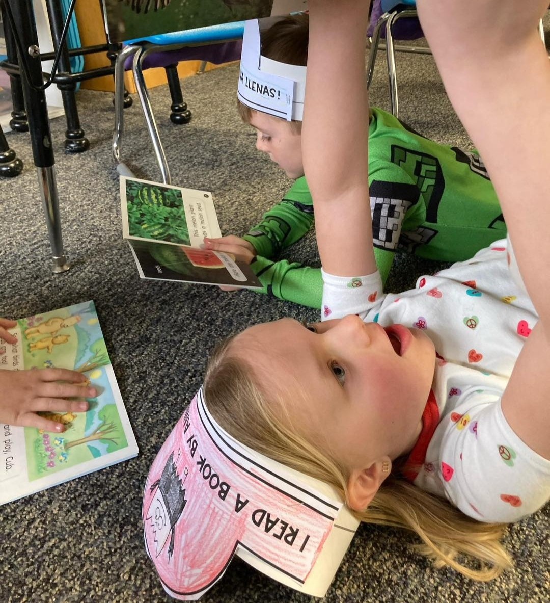 Students reading under desks