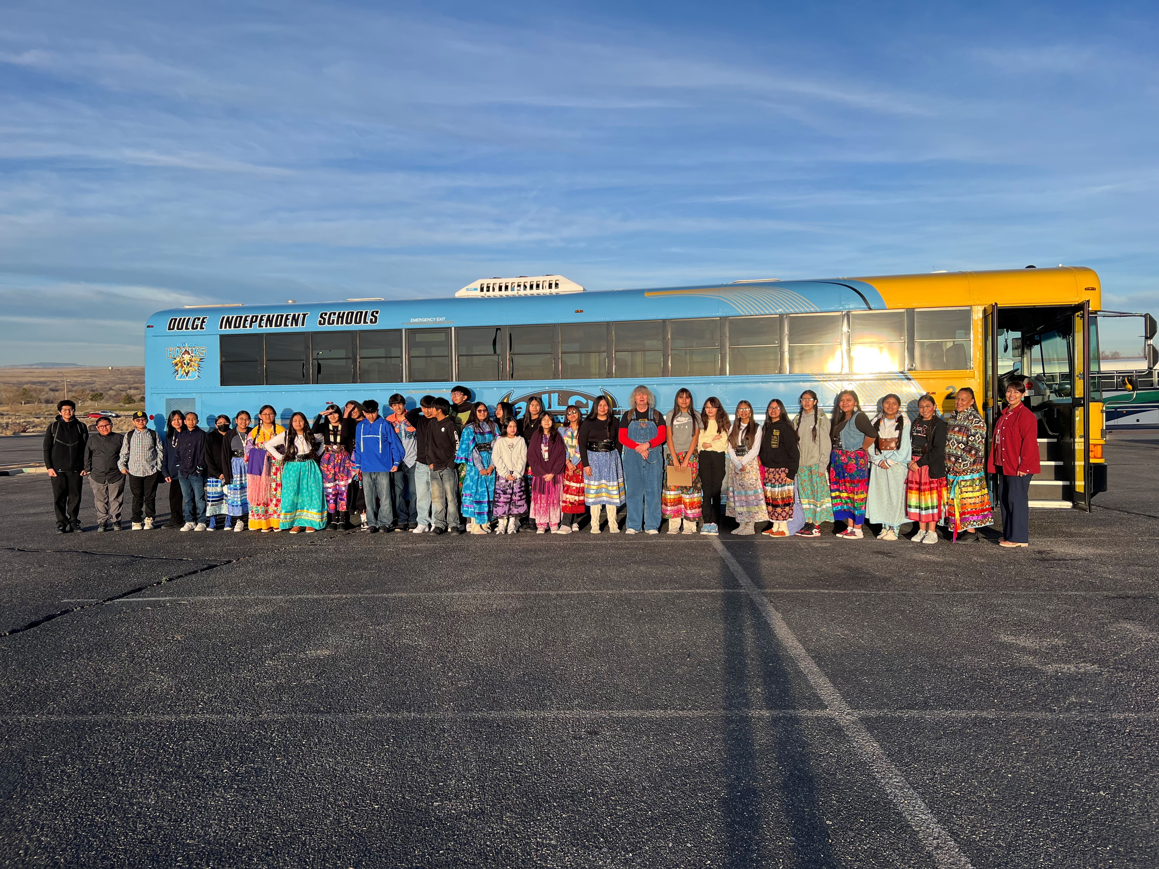 group of people in front of a bus