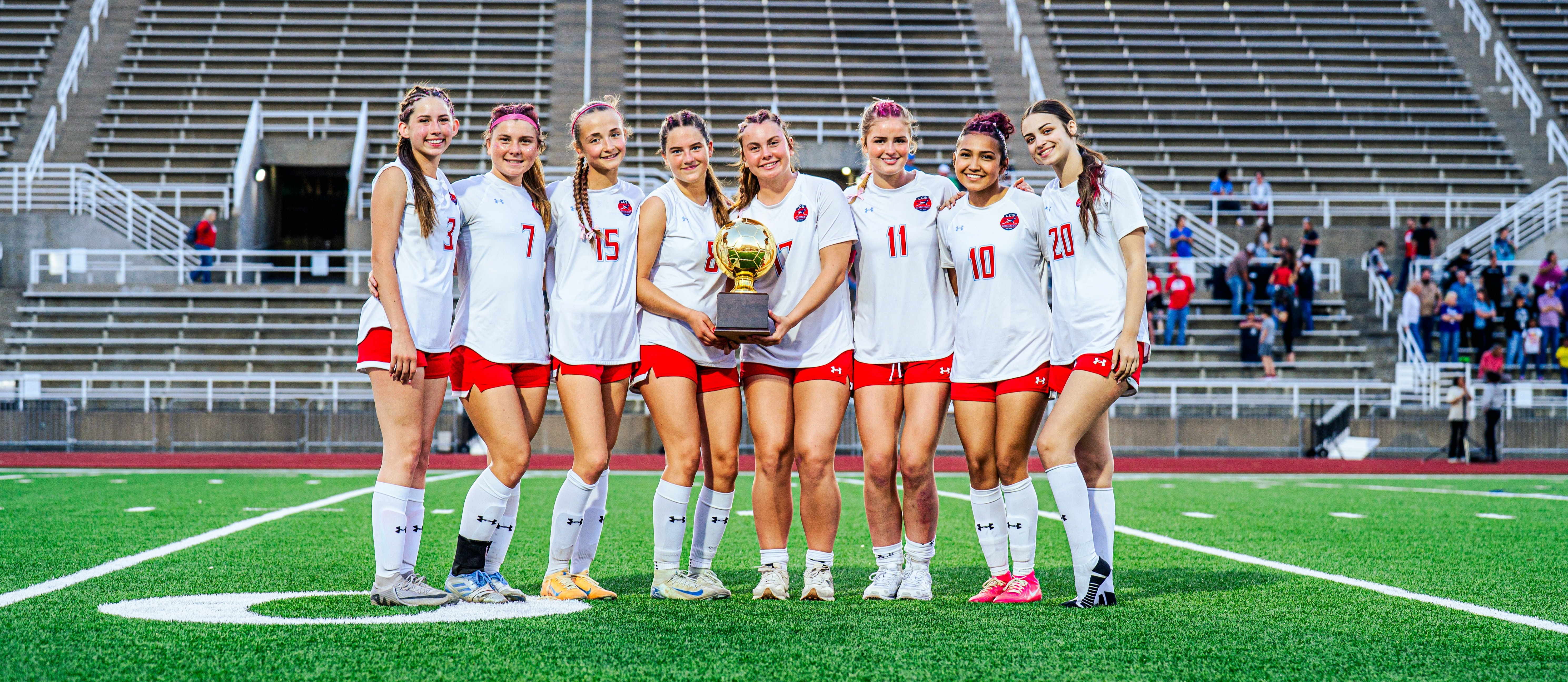 Aubrey High School girls soccer team posing with area championship trophy