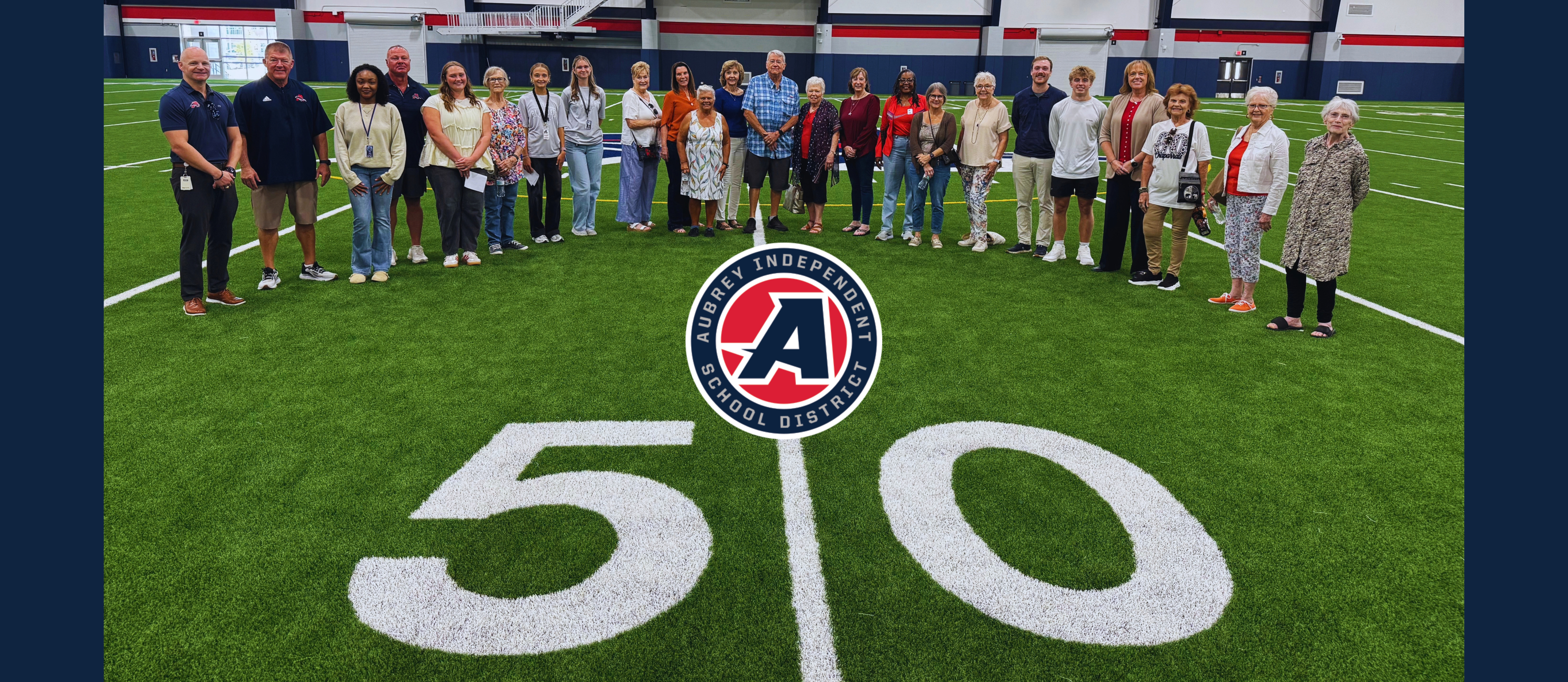 Group photo of Aubrey ISD Chaparral Legacy Cooperative on turf in Aubrey High School Multipurpose Facility