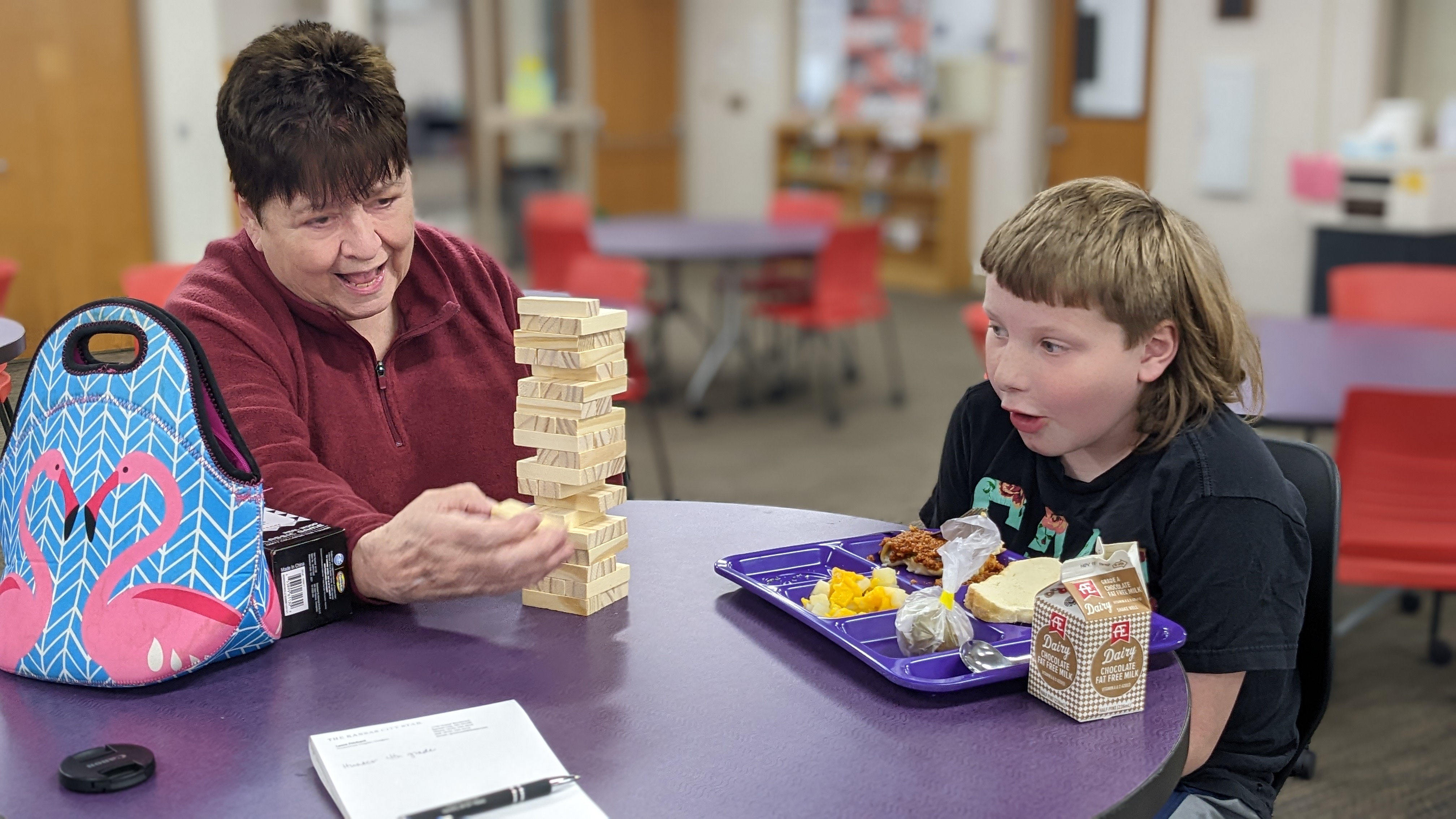 Lunch buddy and student playing game