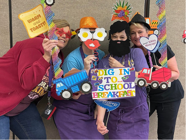 CDIS Nutrition Services Department in photo booth during National School Breakfast Week