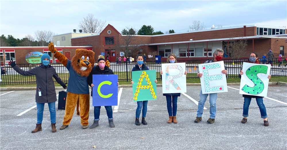 Teacher with letters that read CARES