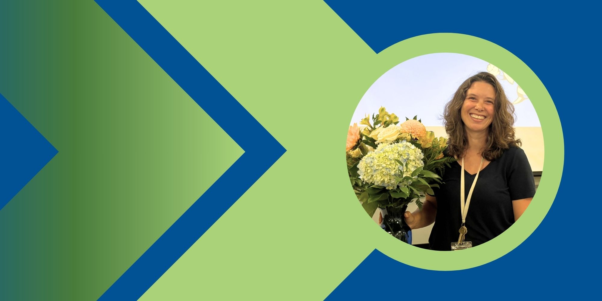 A woman in a black shirt holds a bouquet of flowers. The background features a blue and green arrow pattern.