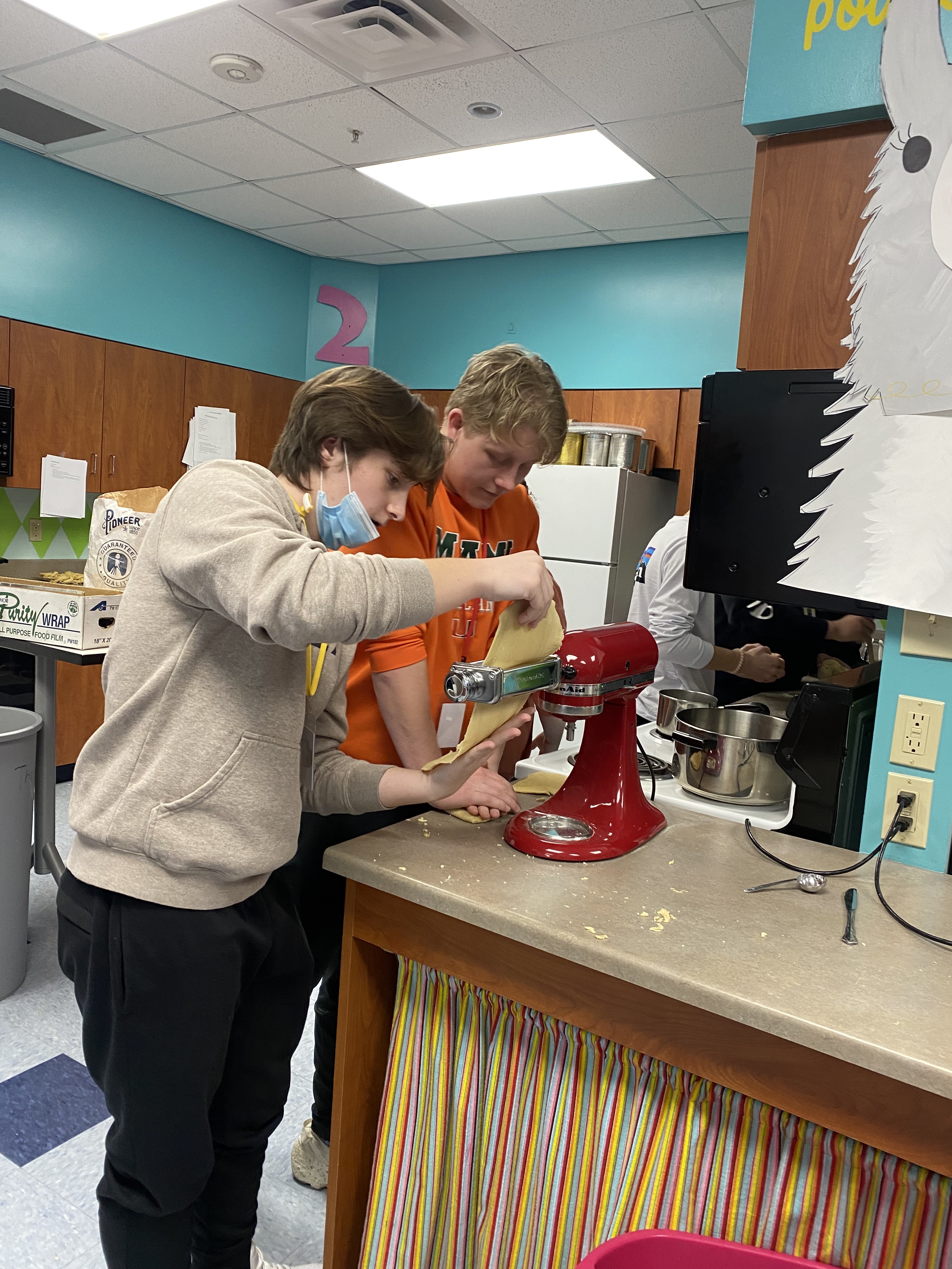 Students working together to use a stand mixer