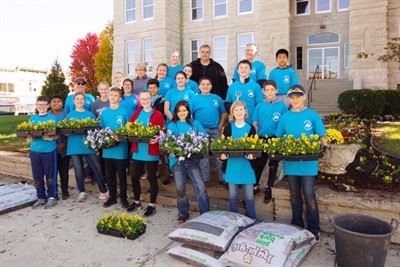 Several members of the community holding flowers