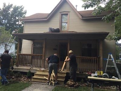 Members of the community repair a home