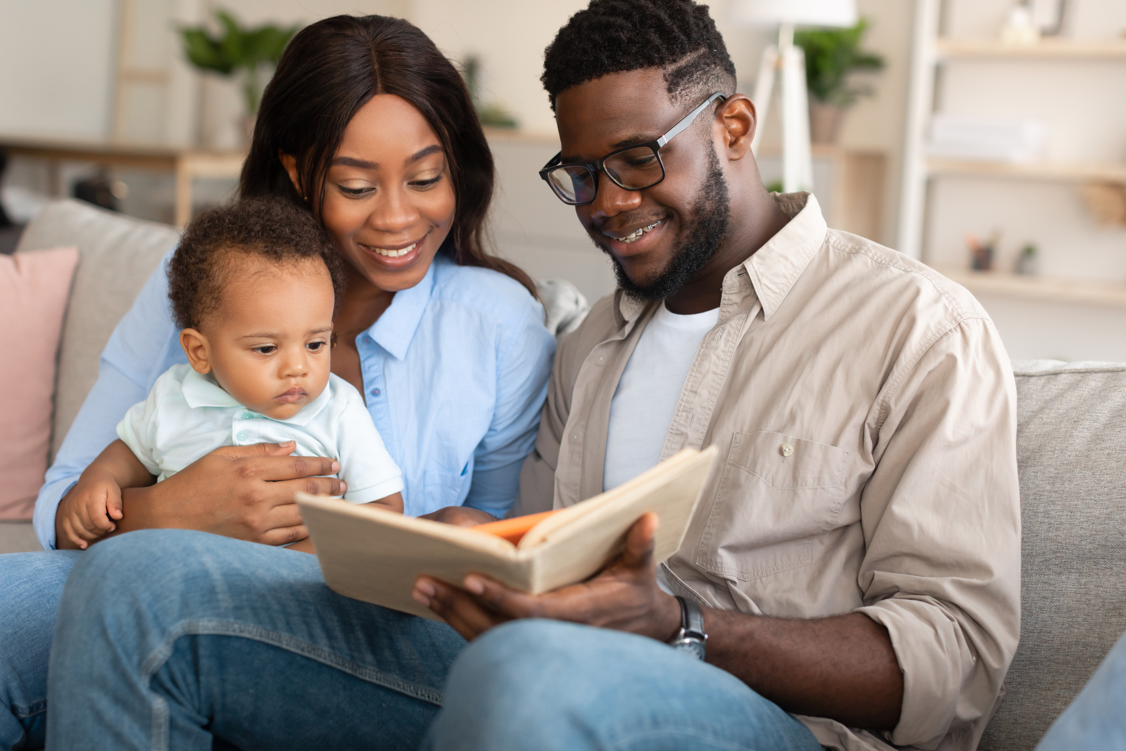 Diverse couple reading to child