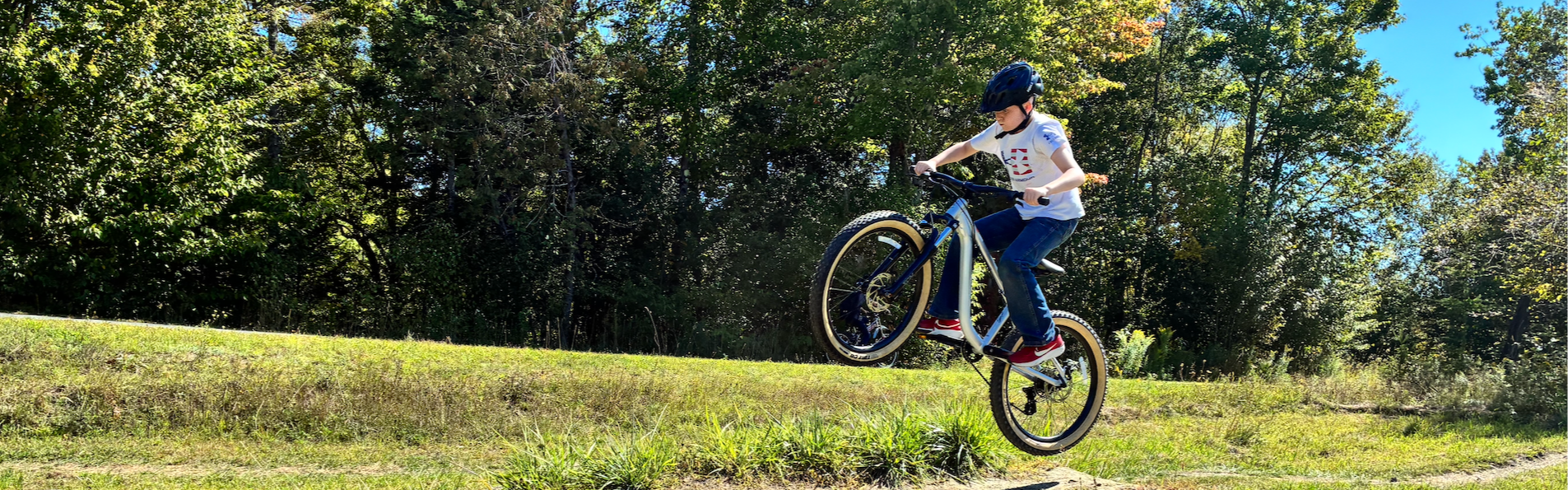 student jumping on a mountain bike