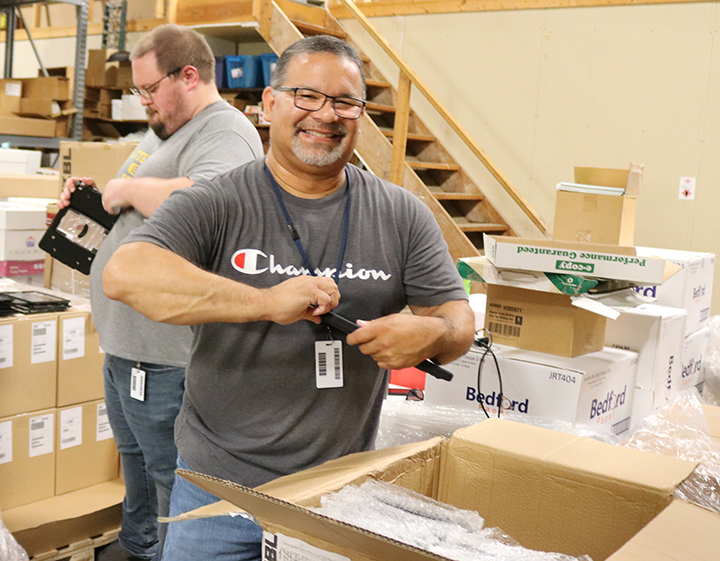 Technicians unloading Chromebooks