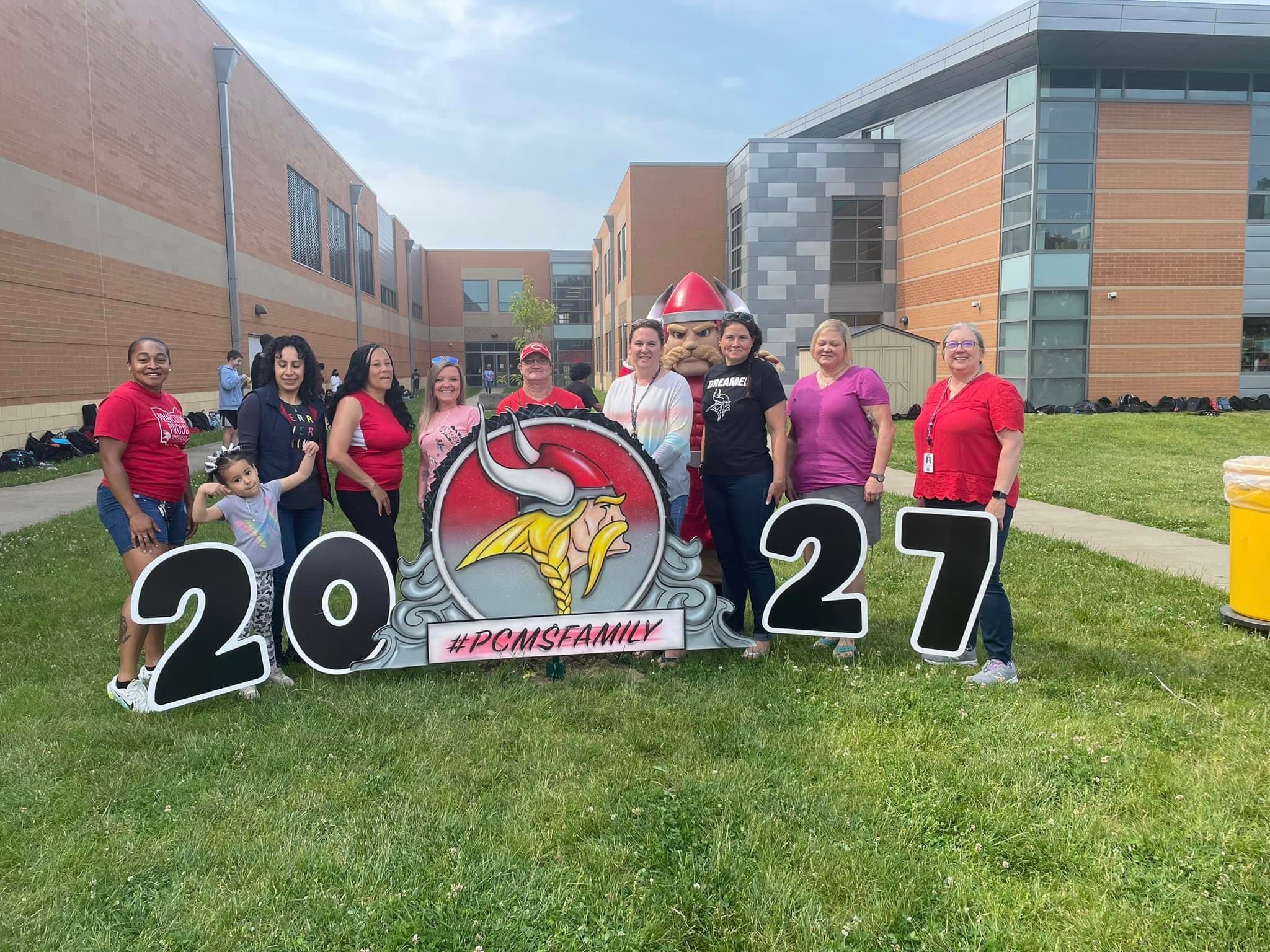 PCMS PFO photo of officers and volunteers with a sign