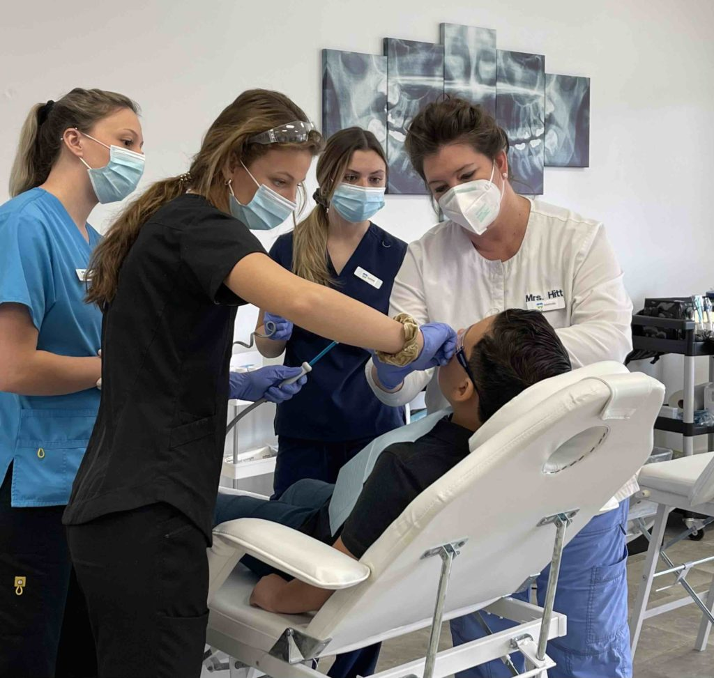 Dental Assistants examining patients teeth