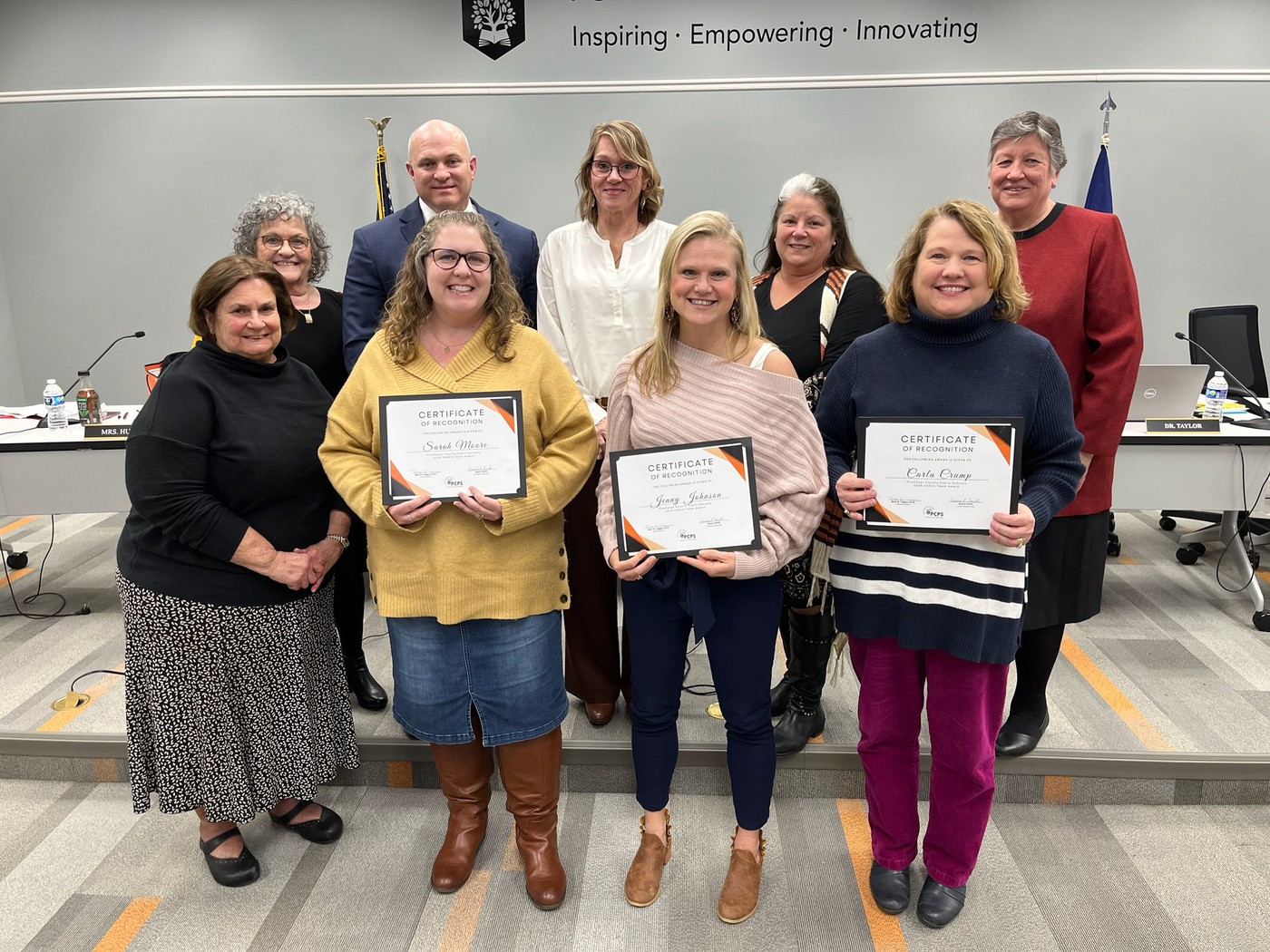 Jenny Johnson, Sarah Moore, and Carla Crump with school board members