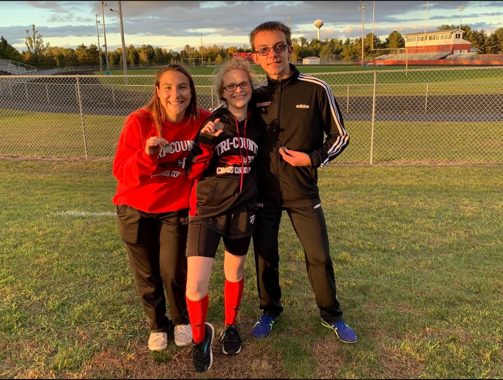 runner posing with friends