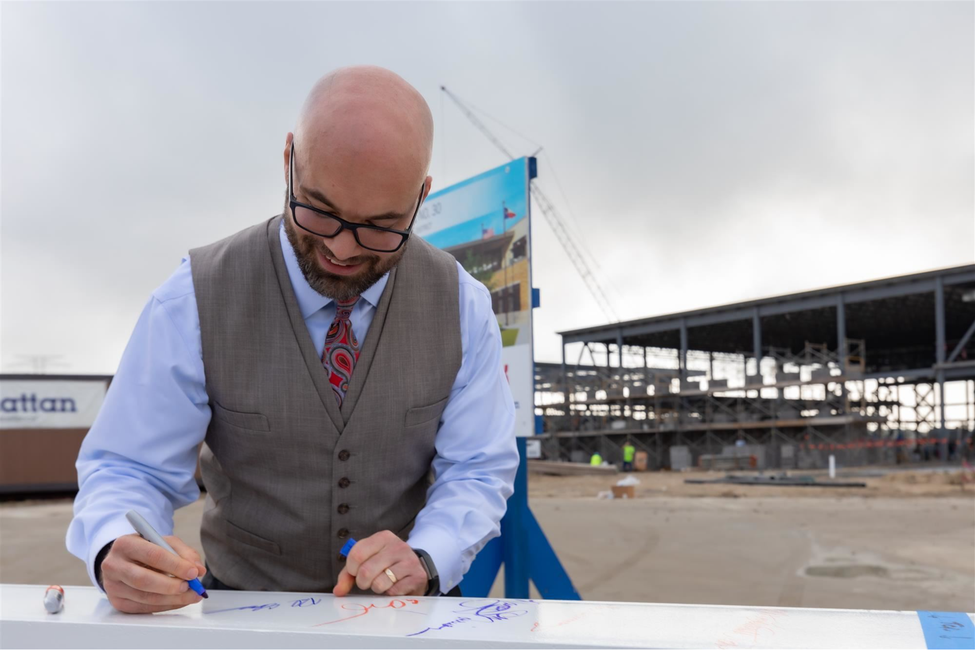 Paul Edwards, the founding principal of Elementary School #30, signs a construction beam at the groundbreaking ceremony for Humble ISD's 30th elementary school. The school opens in August 2021.