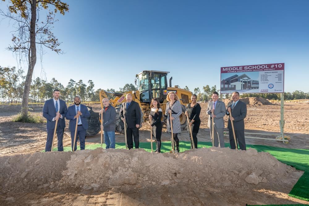 Pictured at the Autumn Ridge Middle School construction site are (from left): Terry Perkins, Deputy Superintendent; Steven Hadley, Executive Director of Construction; Robert Scarfo, School Board Secretary; Robert Sitton, School Board President; Dr. Elizabeth Fagen, Superintendent; Lori Twomey, School Board Parliamentarian; Martina Lemond Dixon, School Board Vice President; Dr. Roger Brown, Deputy Superintendent; and Nolan Correa, Associate Superintendent of Operational Support Services.