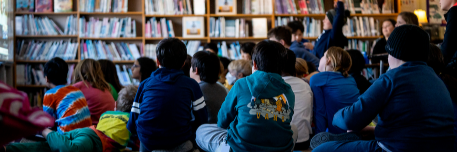 Students sitting on the floor in the library