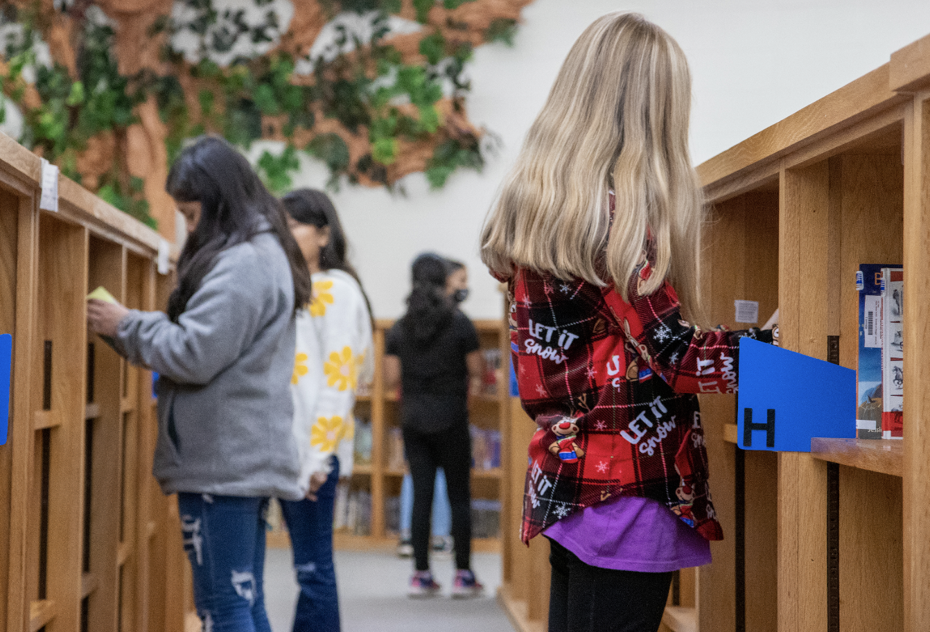 students checking out books