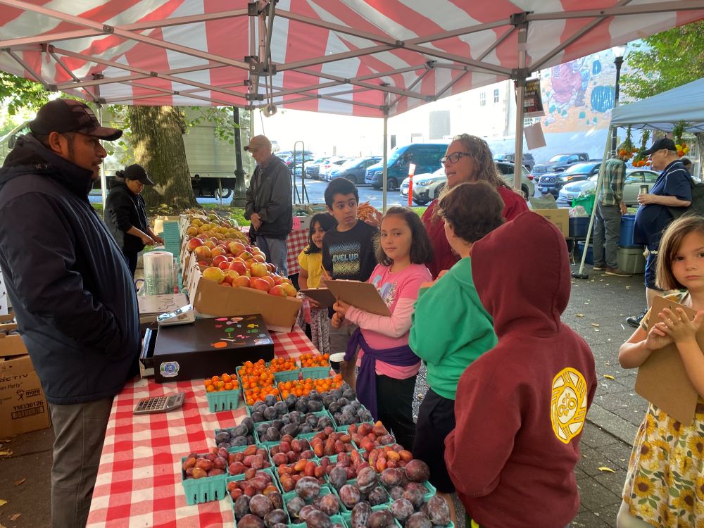 sampling produce at the farmer's market