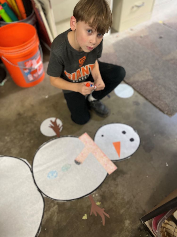 Cooper works on his snowman design