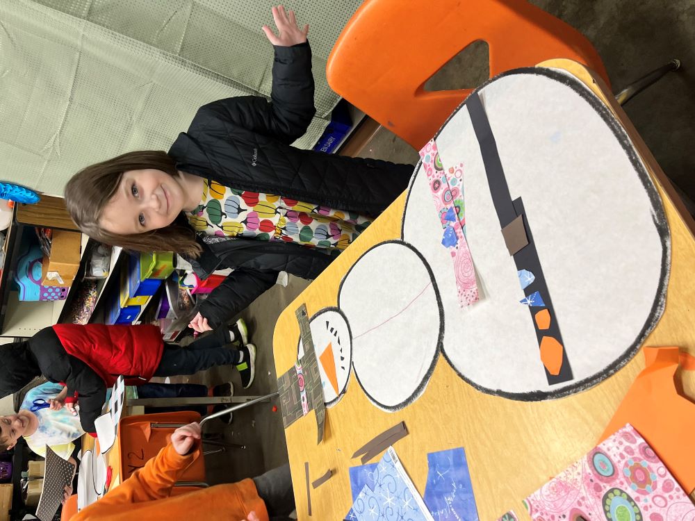 Mabel proudly shows off her finished snowman