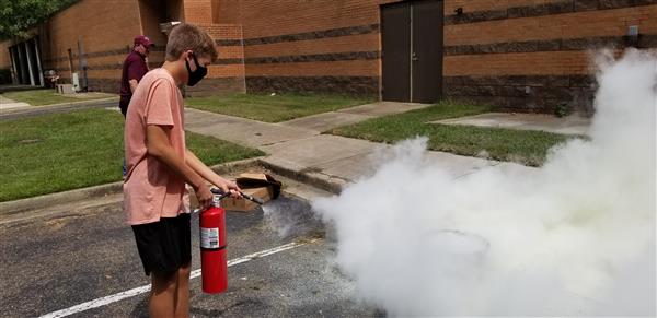 people using a fire extinguisher