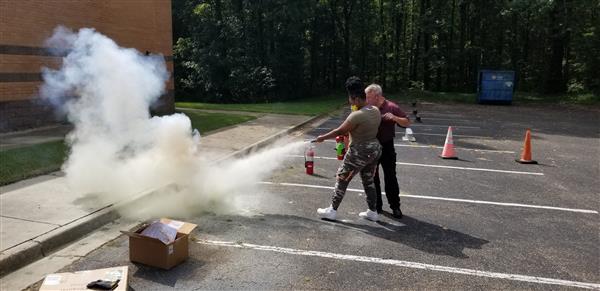 people using a fire extinguisher