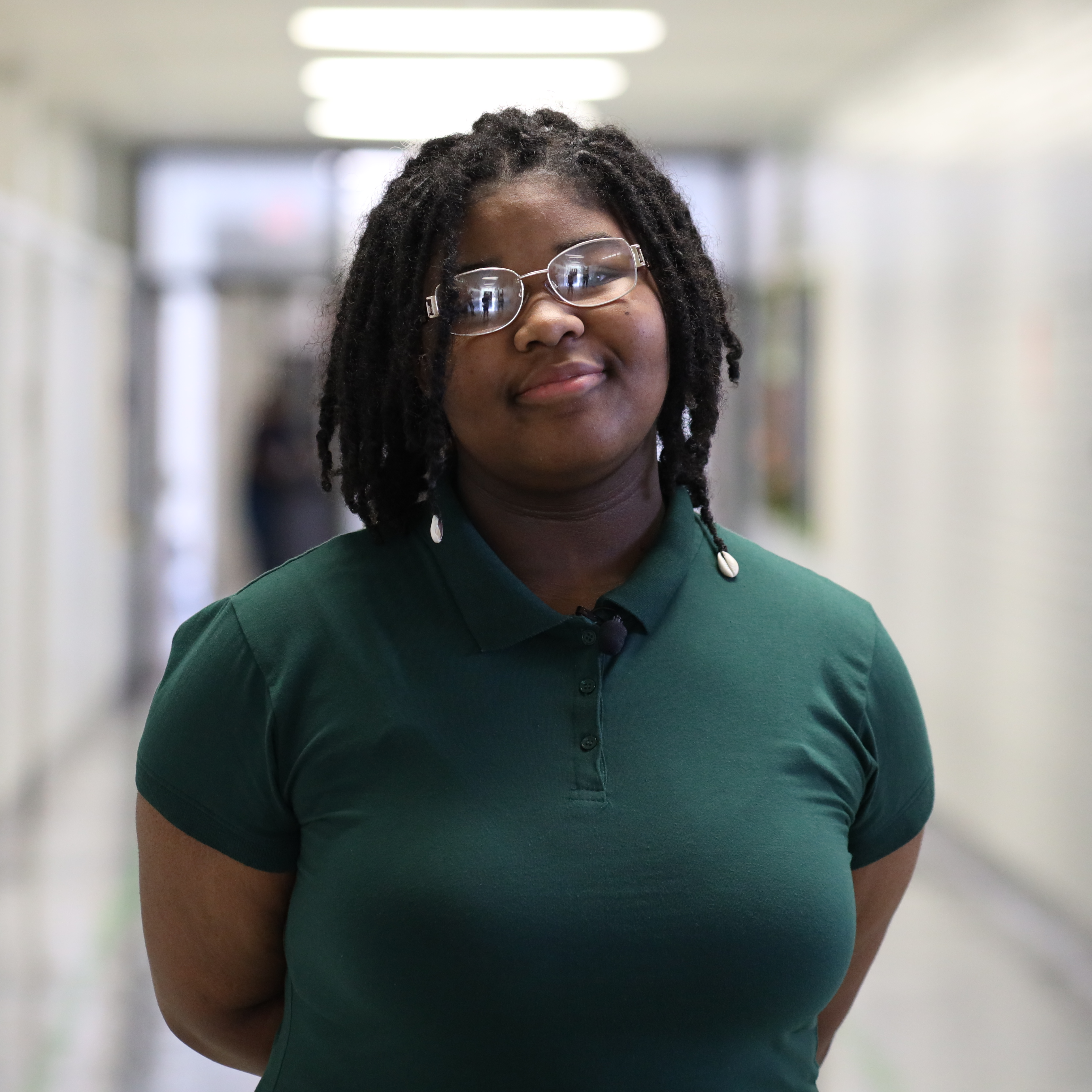 Madyson Brown smiling for a photo in the hallway at Vicksburg Junior High School.