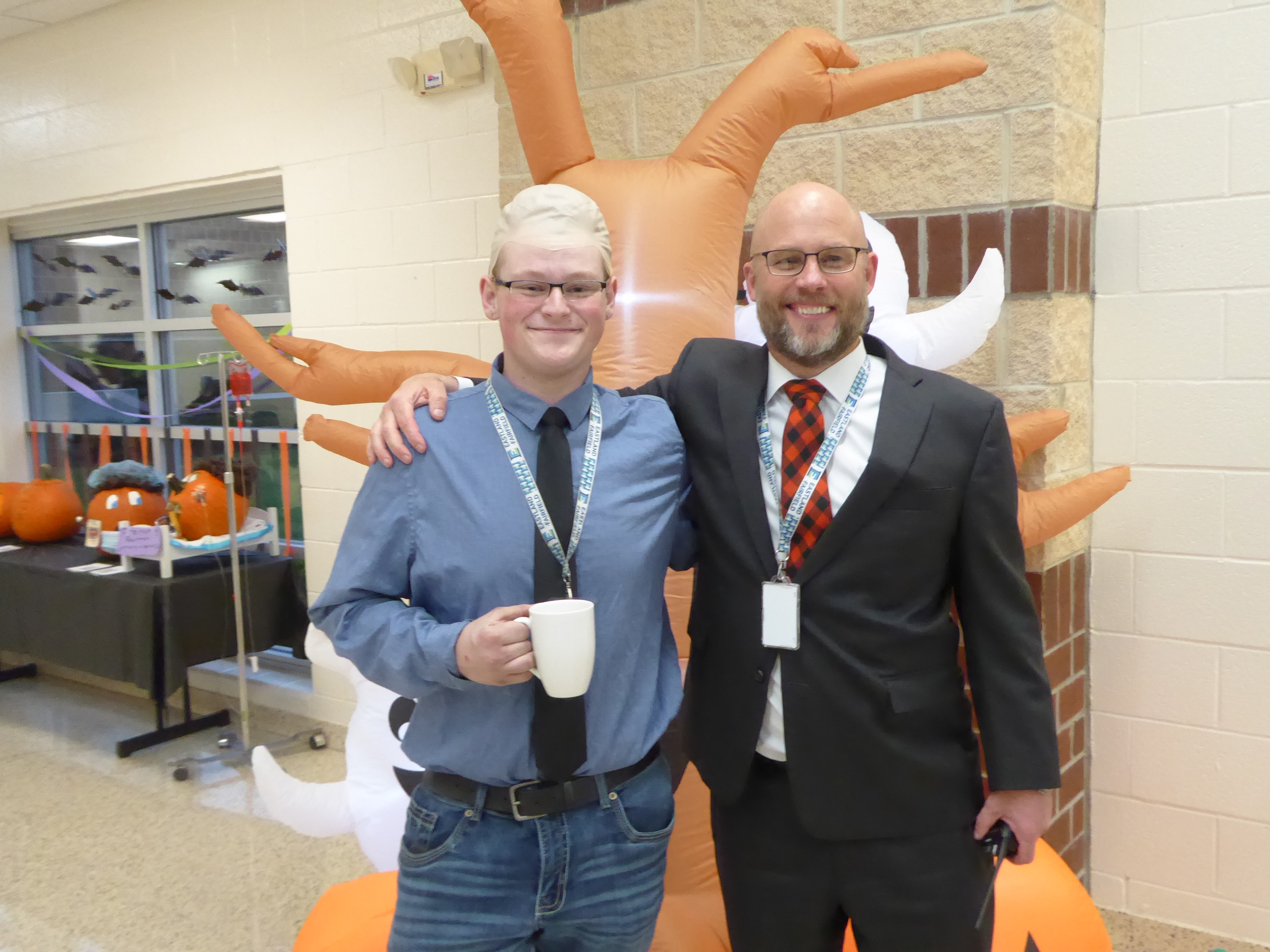 A student dresses as his principal, bald head and all.