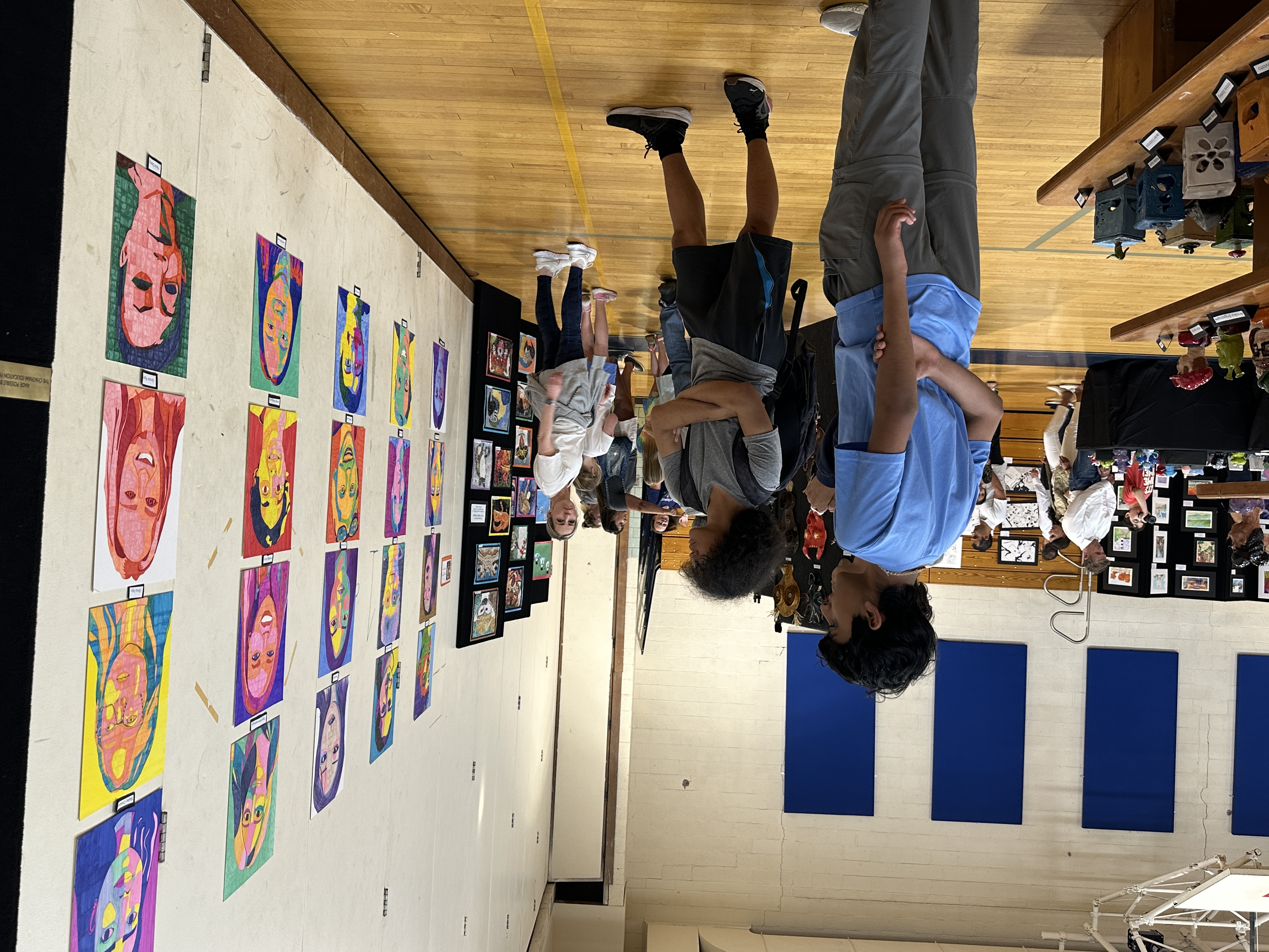 male students looking at artwork 
