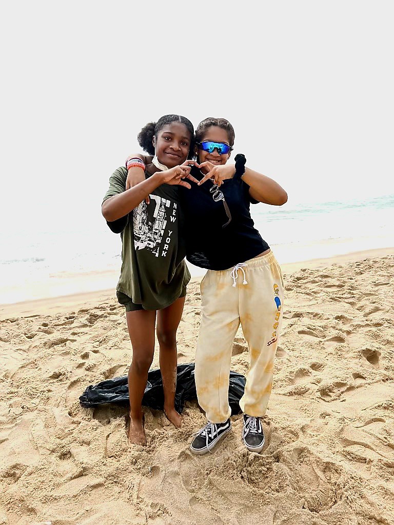 Students posing on beach during cleanup