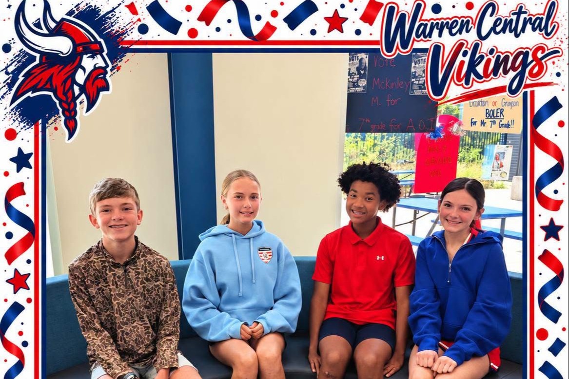 Five children sit together on a bench. Two are in blue jackets, one in red, and two in camouflage. The border includes stars and stripes.