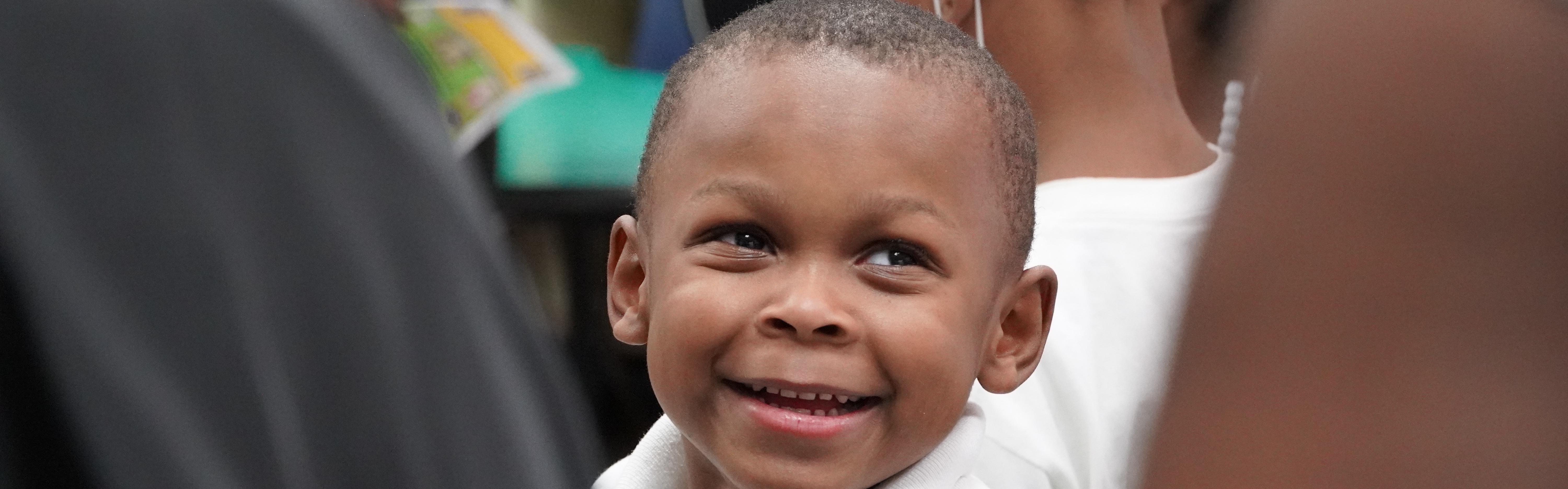 A student smiles in the background as he is seated