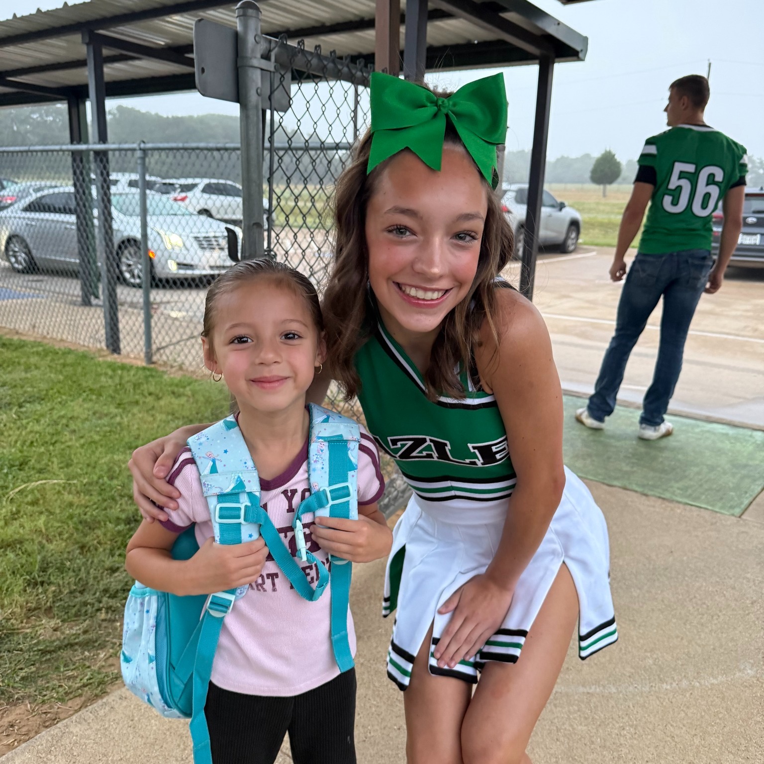 little girl with high school cheerleader