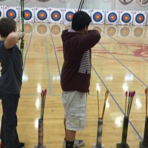 two students shooting bow and arrow