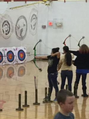 3 people shooting bow and arrow