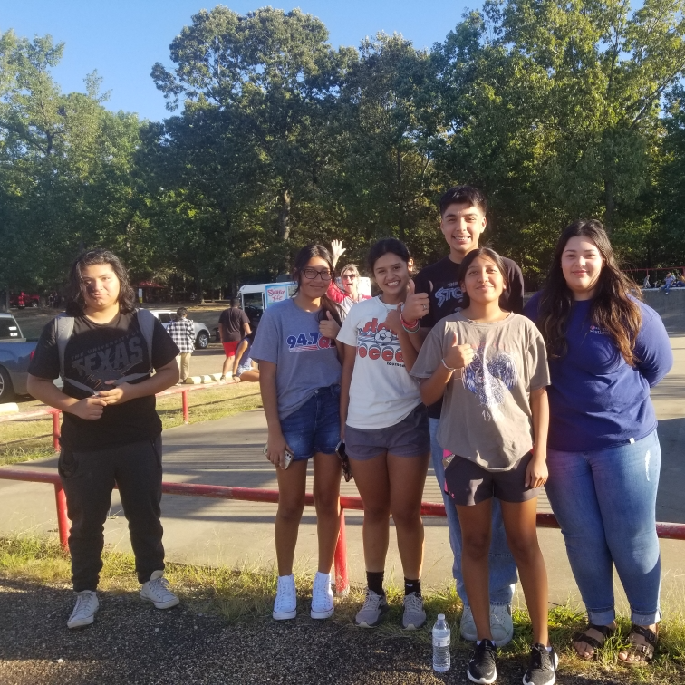 spanish club members standing outside