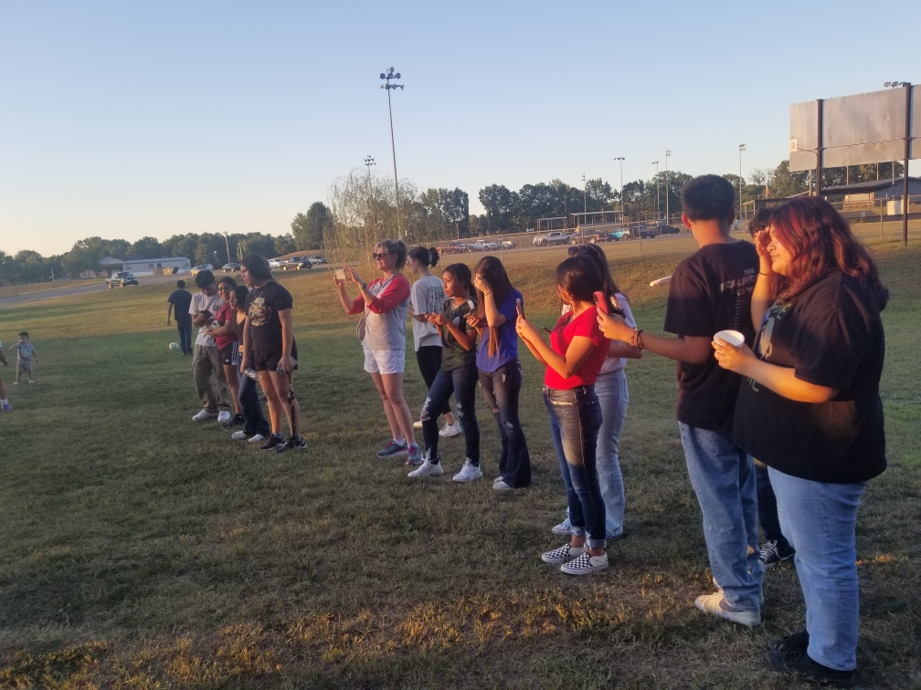 spanish club members standing outside