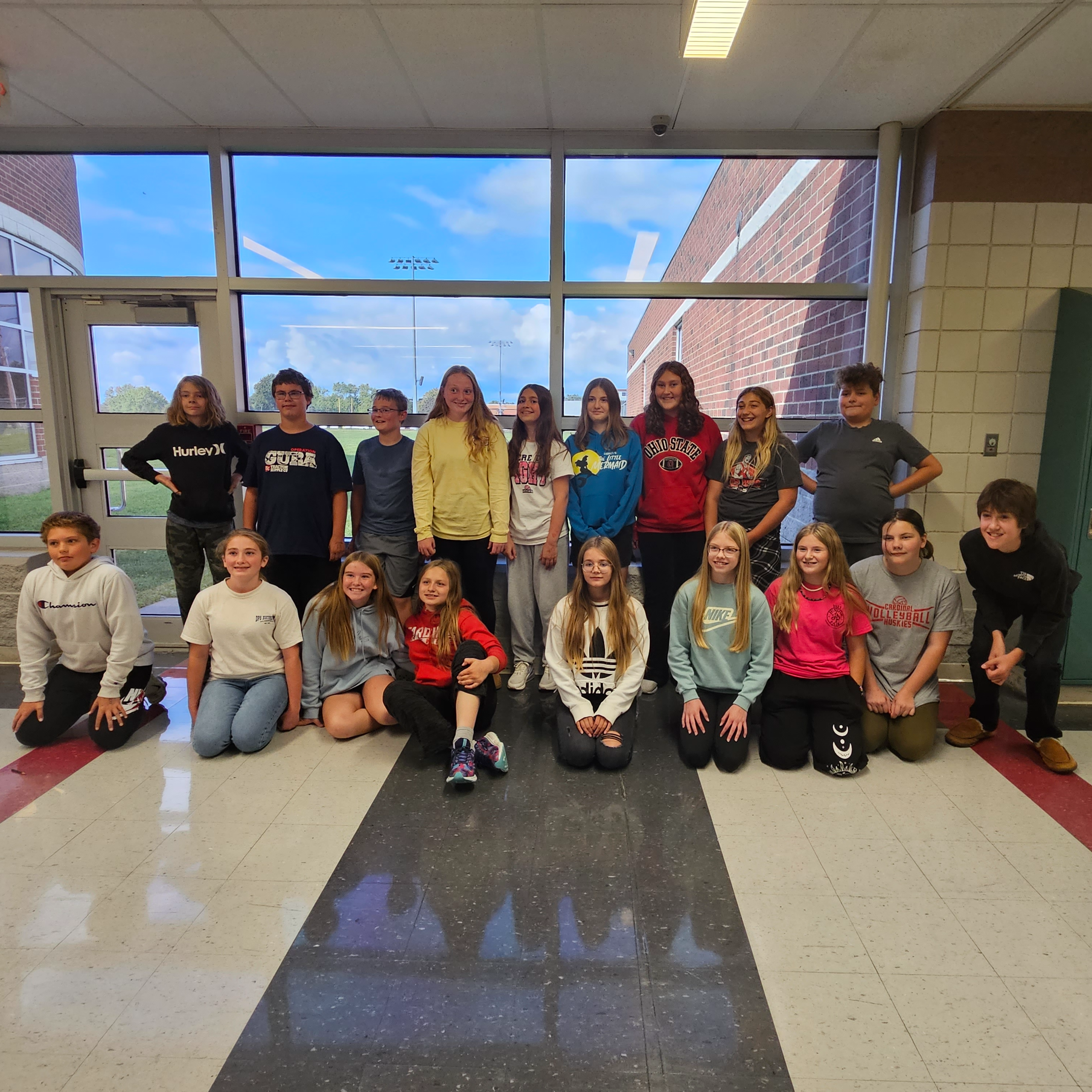 Students in Mr. Bronson's science class pose for a picture after demonstrating what "force" and "gravity is. "