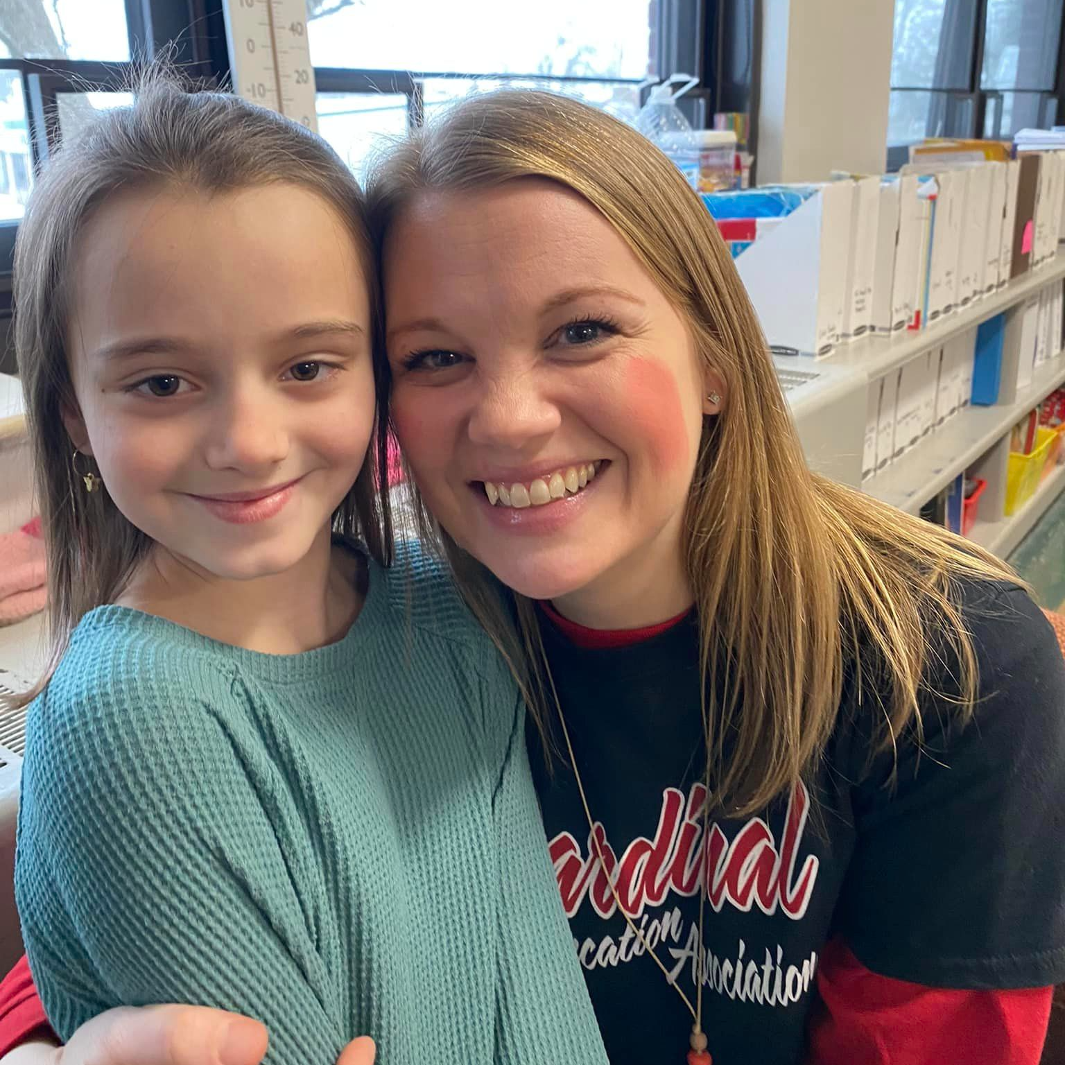 Mrs. Wells is all smiles with one of her first grade students. 